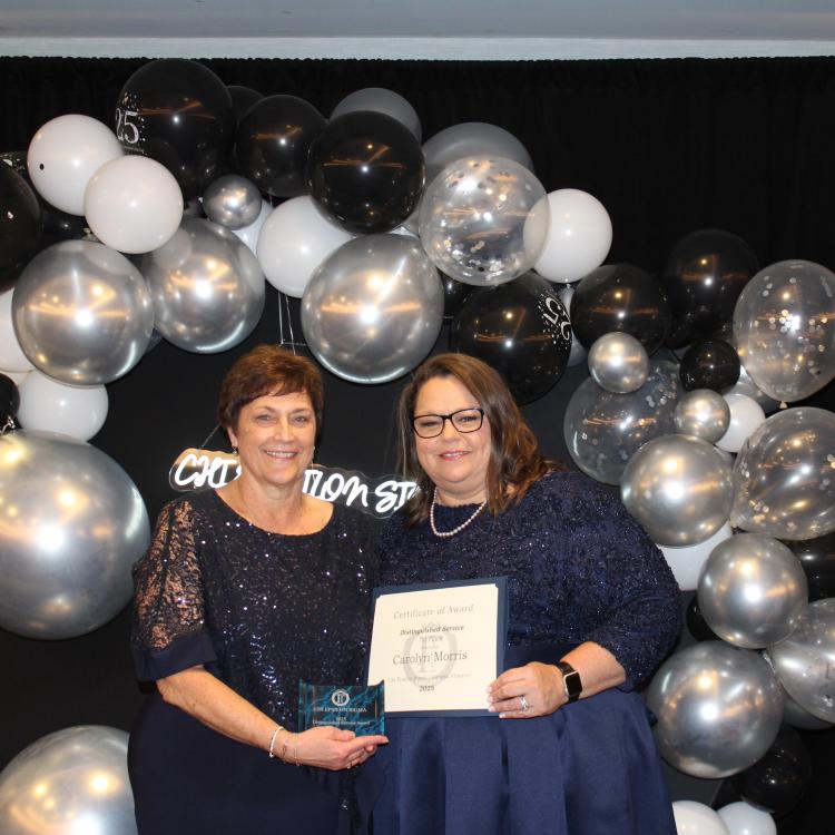  Two women in front of balloons